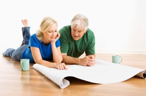 Man and woman discussing blueprints