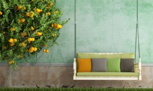 Vintage wooden swing in the garden of an old house in spring