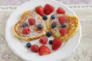 Heart shaped pancakes with fresh berries