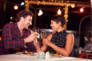 Couple eating dinner at rooftop restuarant