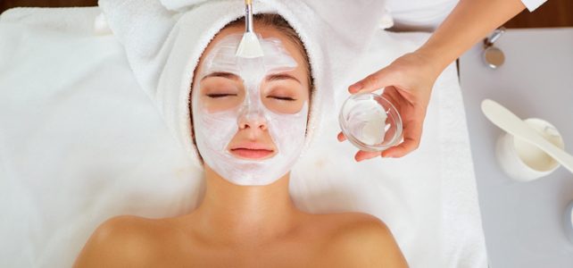 Woman in mask on face in spa beauty salon.