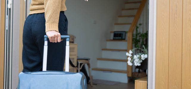 young adult woman travelling from home with suitcase